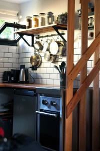 a kitchen with a counter top with pots and pans at Güer Aike Mejor Tiny house c/ vista al Fitz Roy in El Chalten