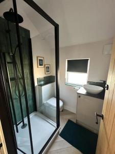 a bathroom with a shower and a toilet and a sink at Bronte Cottage - Quirky, central, 2bed, seaside in Hornsea