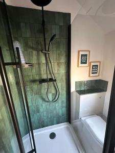 a bathroom with a shower with a glass door at Bronte Cottage - Quirky, central, 2bed, seaside in Hornsea