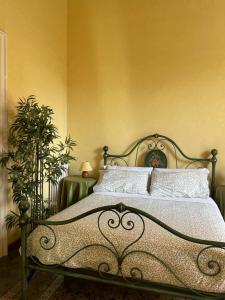 a bed in a bedroom with a yellow wall at Inn The Garden in Catania