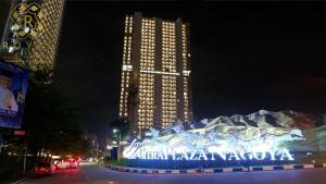a building with a sign in front of it at night at Royal Suites Studio 17th Floor - Citra Plaza Nagoya Apartment in Jodoh