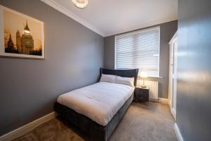a bedroom with a bed in a room with a window at Bannerdale Villa 5 bedroom in Nether Edge