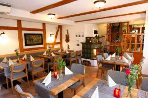 a restaurant with tables and chairs in a room at Hotel Wenzels Hof in Zwethau