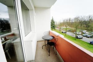 uma varanda com 2 cadeiras e uma mesa em frente a uma janela em Jenapartments for7 Boxspring & Smart TV & Waschmaschine em Jena