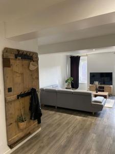 a living room with a bed and a couch at L'appart Saint-Laurent in Chalon-sur-Saône