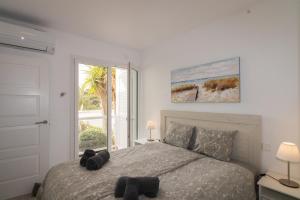 a bedroom with a large bed and a window at Playa d'Or 16 / Cala D'Or / Mallorca in Cala d´Or +32 photos