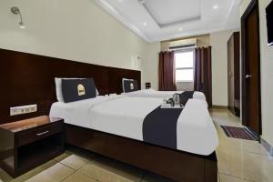 a bedroom with a large white bed in a room at Tipsyy Heritage Heights in Jaipur +29 photos