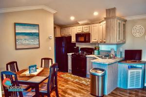 a kitchen with a table and a dining room at Pinecraft Cottage Tiny Home in Sarasota