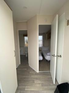 an empty room with a bedroom and a bed at 11 Meadow View in Newquay