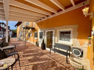 a patio with tables and chairs and a building at Europa Pension zum Grünen Baum in Rust