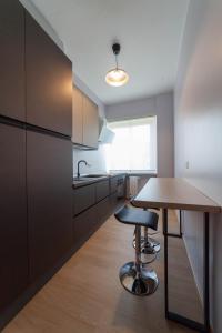 a kitchen with a wooden table and a counter at Casa Margherita C in Bergamo