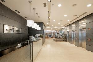 a lobby of an office building with a long hallway at Attica21 Coruña in A Coruña