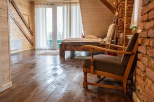 a living room with a chair and a bed at Apartmaji Babi in Markovci