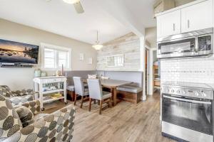 a kitchen with a table and a dining room at Secluded Cabin On The Lake #7 in West Kelowna