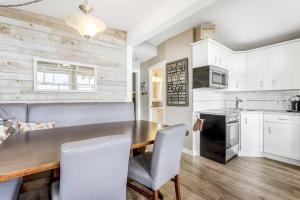 a kitchen with a wooden table and white cabinets at Secluded Cabin On The Lake #7 in West Kelowna +19 photos