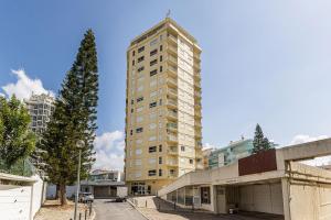 a tall building with a cross on top of it at Beachside Bliss in Armação de Pêra