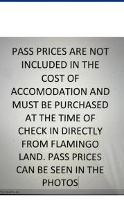 a sign that says pass prices are not included in the cost of accommodation at N and B caravan hire Flamingo Land in Kirby Misperton