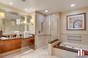 a bathroom with a shower and a sink and a tub at MGM Signature-07-607 Accessible Strip View Balcony in Las Vegas