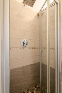 a shower with a glass door in a bathroom at B&B Corsini in Bologna