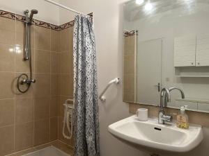 a bathroom with a sink and a shower at 611 - Maison 9 couchages, proche du Cap d'Erquy in Erquy +18 photos