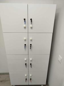 a white cabinet with four knobs on it at Aydeniz hostel in Chişinău