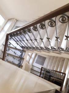 a staircase with a metal railing in a building at Hotel Mariano in Rome