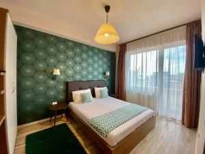 1 dormitorio con 1 cama con pared verde en Best View Summerland, en Mamaia