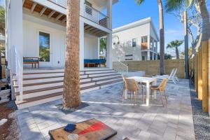 a patio with a table and chairs on a house at Sunset Cove 2 - Heated Pool - Sea Views - Walkable in Saint Augustine