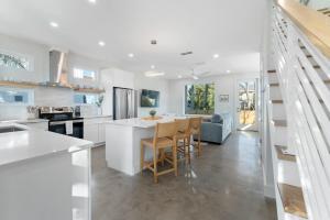 a kitchen and living room with a table and chairs at Sunset Cove - Heated Pool - Sea Views - Walkable in Saint Augustine