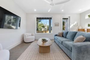 a living room with a blue couch and a table at Sunset Cove - Heated Pool - Sea Views - Walkable in Saint Augustine