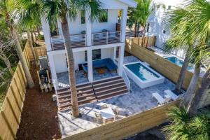 an aerial view of a house with a swimming pool and palm trees at Sunset Cove - Heated Pool - Sea Views - Walkable in Saint Augustine