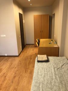 an empty room with a bed and a cabinet at RVR Smart Apartments Riga with Self Check-In in Rīga