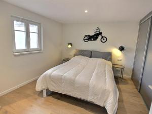 a bedroom with a bed with a motorcycle on the wall at Maison Geispolsheim, 5 pièces, 8 personnes - FR-1-722-5 in Geispolsheim