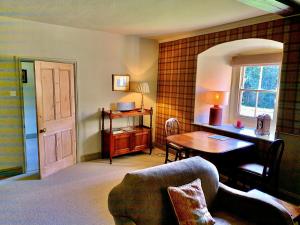 a living room with a desk and a table at Finest Retreats - Ingleby Manor - Gun Room in Great Ayton