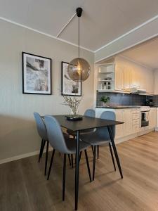 a kitchen and dining room with a table and chairs at Steiroveien in Sortland