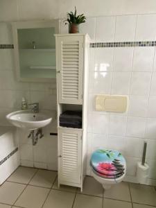 uma casa de banho com um WC e um lavatório em Haus Monika em Homburg
