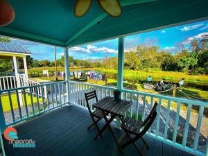 a porch with a table and chairs and a view of the water at Pinecraft Tiny Home 2 in Sarasota