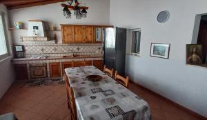 eine Küche mit einem Tisch und einem Kühlschrank in der Unterkunft Villa Annamaria in Carini