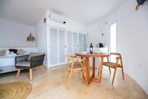 a dining room with a table and chairs and a bed at Agi Castell Mar in Roses