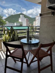 a table and chairs on a balcony with a view at Andes Suites Premium in Salta