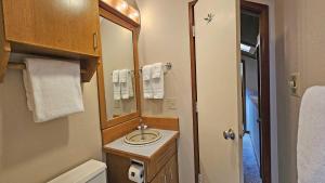 a small bathroom with a sink and a mirror at Mountain View Lodge 2 in Sunriver +9 photos