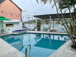 a swimming pool with a view of the water at Hotel Sabana in Flores