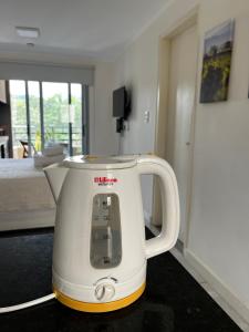 a white tea kettle sitting on the floor in a room at Andes Suites Premium in Salta