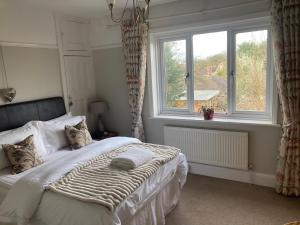a bedroom with a large bed and a window at ABI B&B in Kent