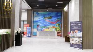 a large painting of a mermaid on a wall in a building at Royal Suites Studio 28th Floor - Citra Plaza Nagoya Apartment in Jodoh +18 photos