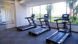 a group of treadmills in a gym with a window at Royal Suites Studio 28th Floor - Citra Plaza Nagoya Apartment in Jodoh