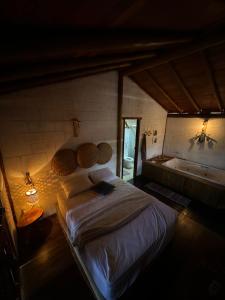 a bedroom with a large bed and a bath tub at Pousada Reserva Setiba Guarapari in Guarapari
