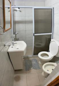 a bathroom with a toilet and a sink and a shower at Luz maria in Empedrado