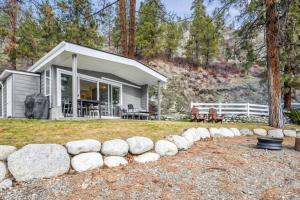 a small house with a bunch of rocks around it at Family-friendly Cottage with amazing views in West Kelowna