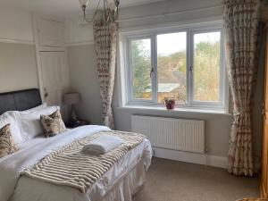 a bedroom with a bed and a large window at ABI B&B in Kent